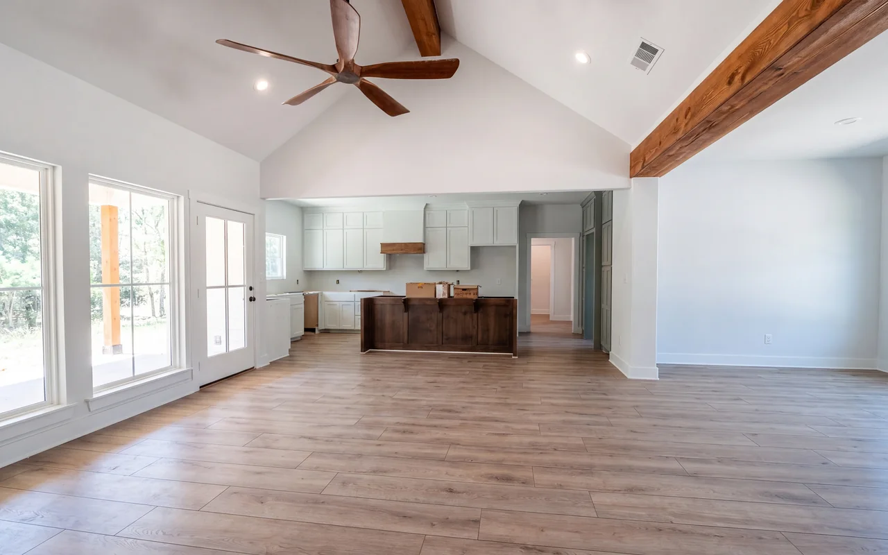 Wood-look plank flooring through a vaulted great room and kitchen